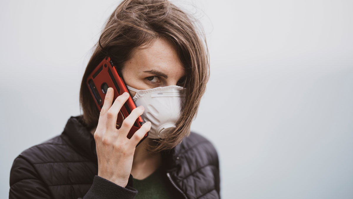 Masked lady on mobile phone