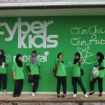 Cyberkids participants posed at the school&rsquo;s computer lab wall which has been painted with Cyberkids logo